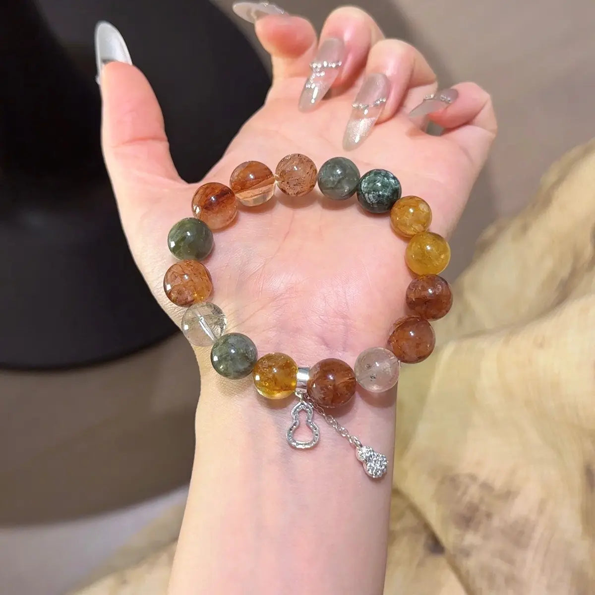 Handcrafted yellow-hematoid-quartz; red-hematoid-quartz; green-phantom-quartz; seraphinite; black-gold-super-seven; emerald Detail for Abundance - Astara