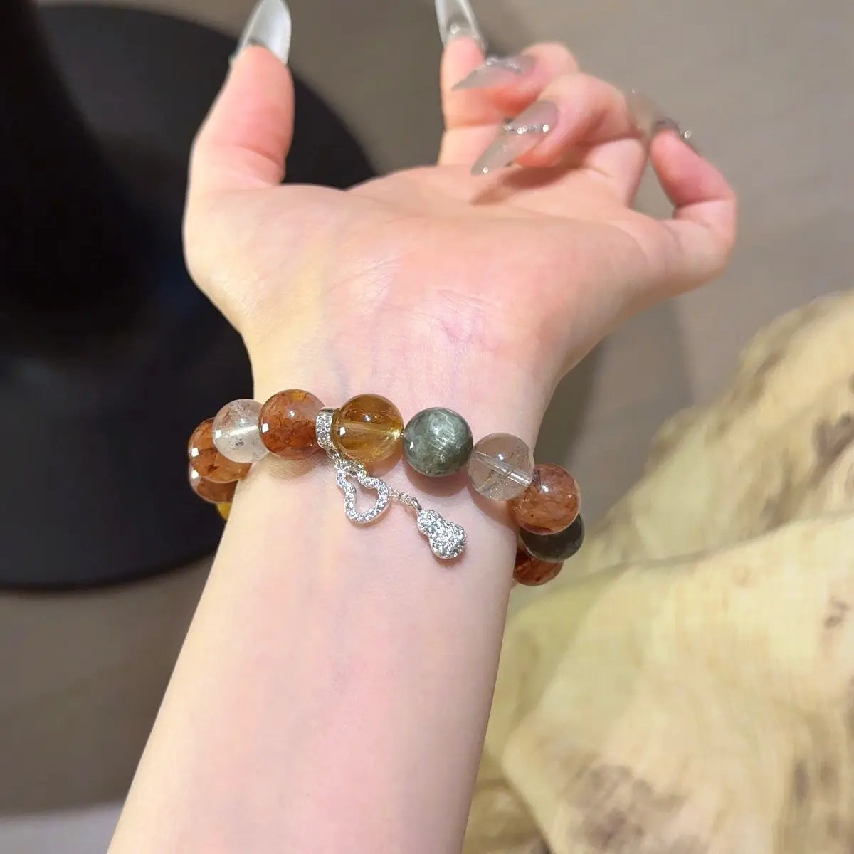 Handcrafted yellow-hematoid-quartz; red-hematoid-quartz; green-phantom-quartz; seraphinite; black-gold-super-seven; emerald Detail for Abundance - Astara