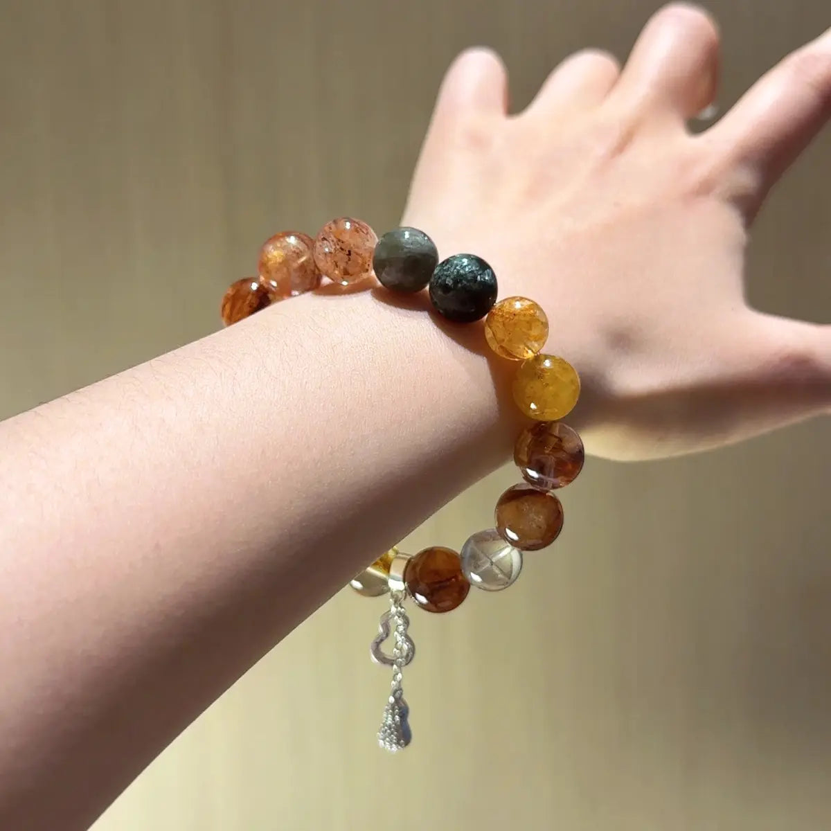 Handcrafted yellow-hematoid-quartz; red-hematoid-quartz; green-phantom-quartz; seraphinite; black-gold-super-seven; emerald Detail for Abundance - Astara